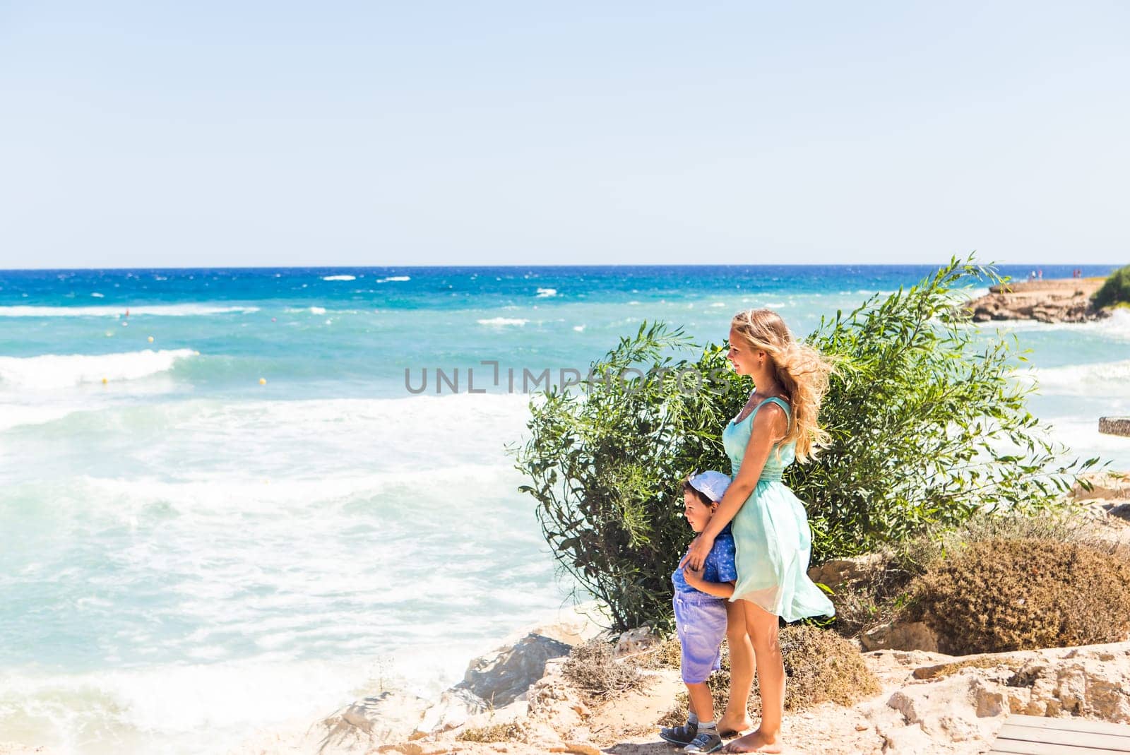 Portrait of happy mother and son at sea, outdoor.