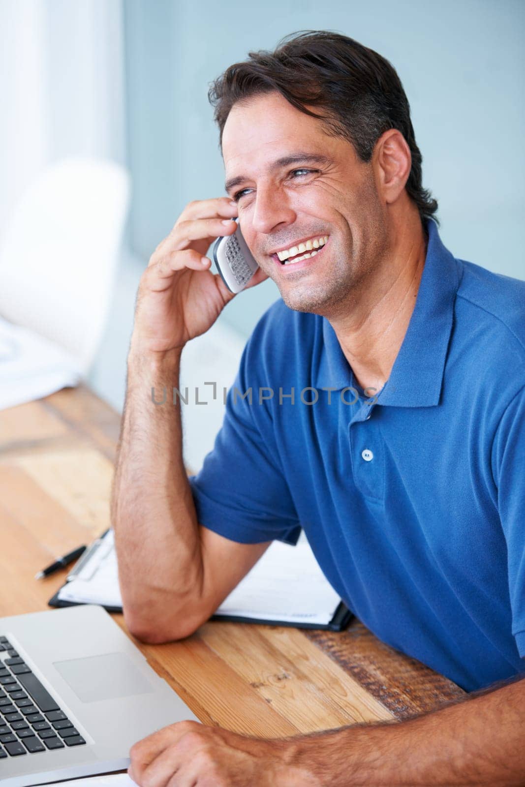 Businessman, laugh and phone call for communication in modern office for talk, schedule or conversation. Mature person, entrepreneur and happy for working in startup by mobile, internet or cellular.