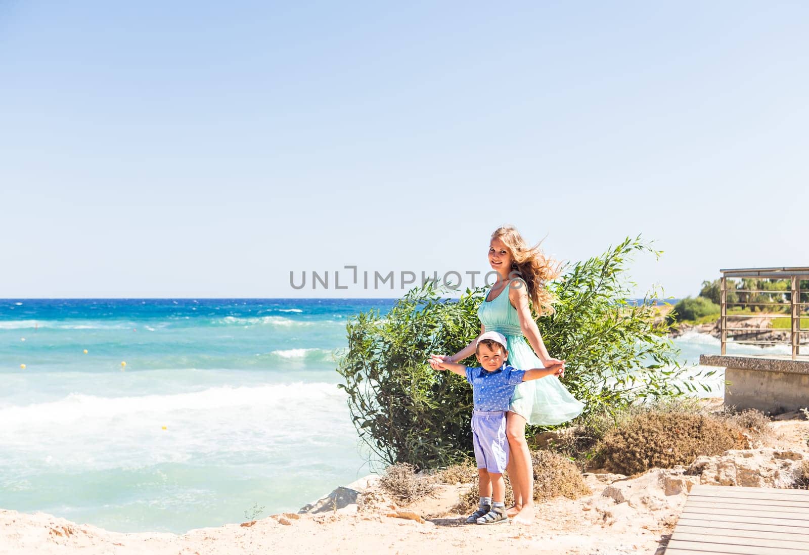 Portrait of happy mother and son at sea, outdoor.