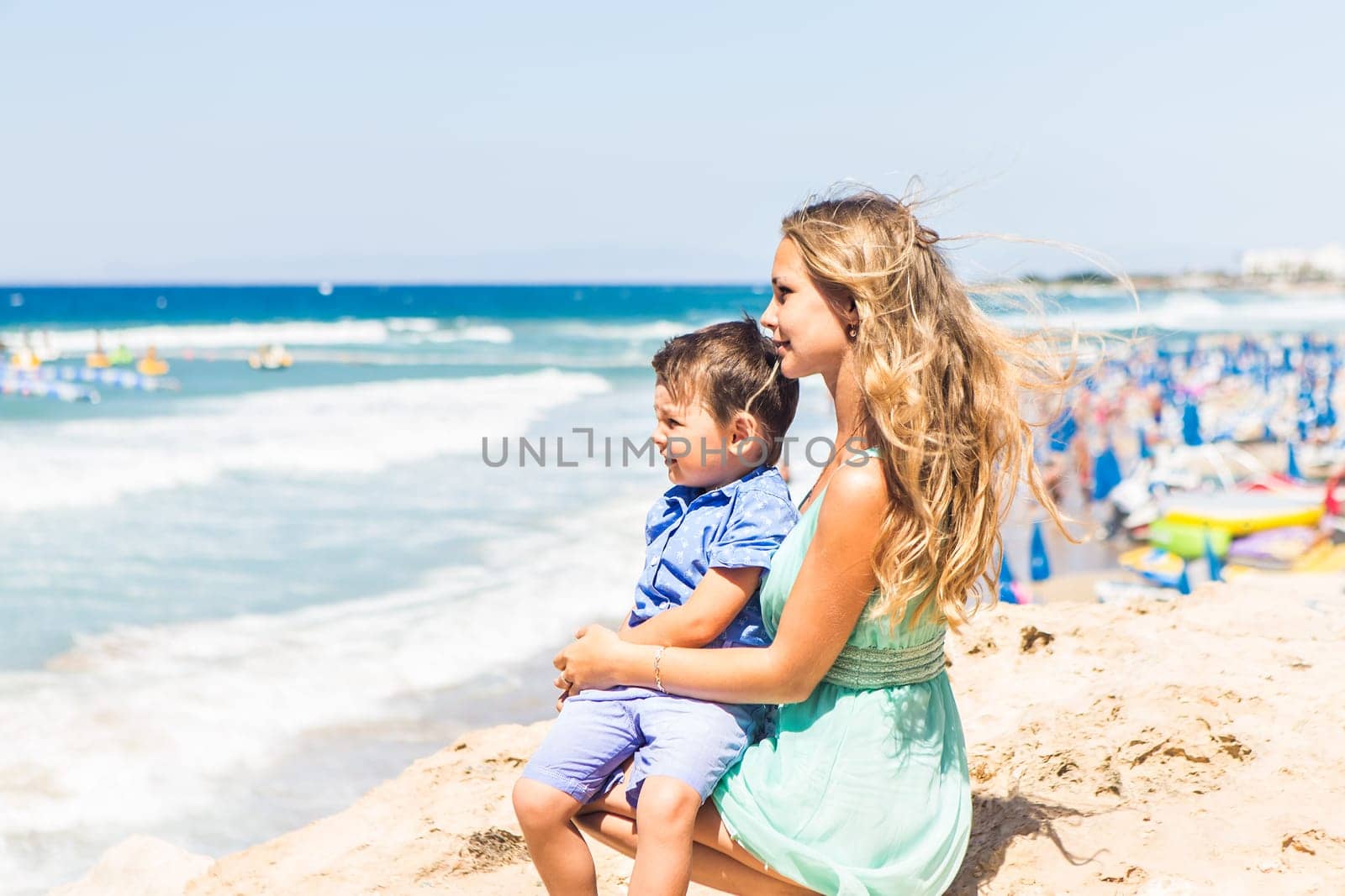 Portrait of happy mother and son at sea, outdoor.