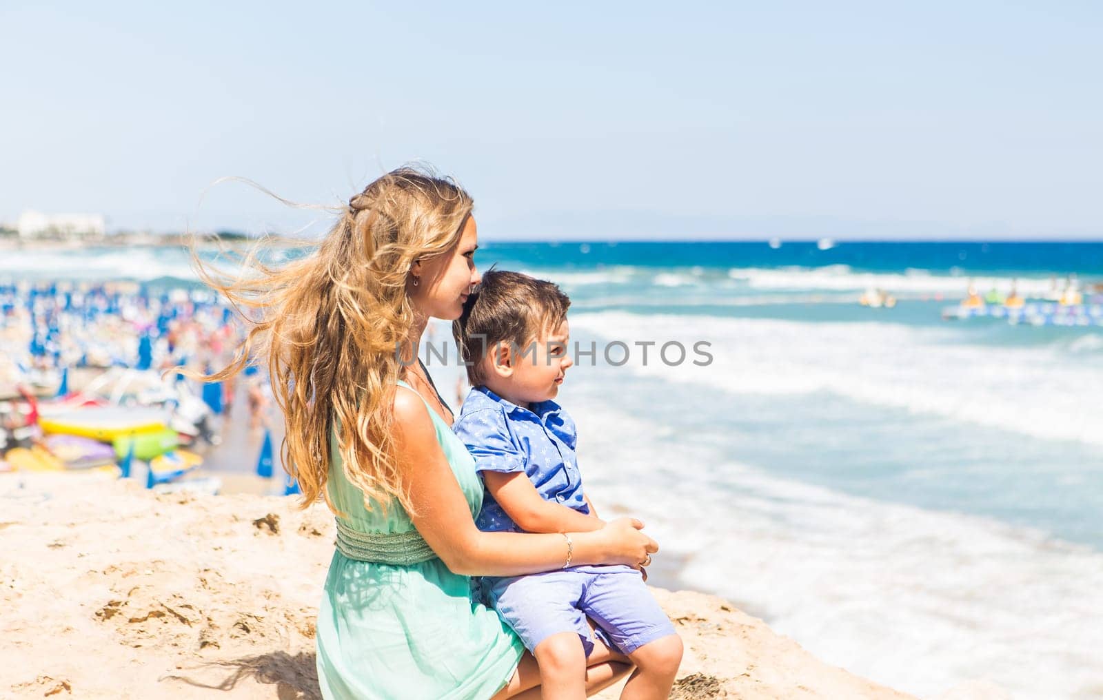 Portrait of happy mother and son at sea, outdoor.