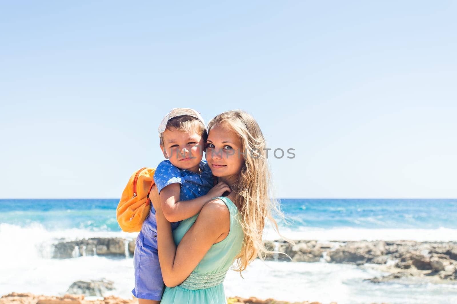 Portrait of happy mother and son at sea, outdoor.