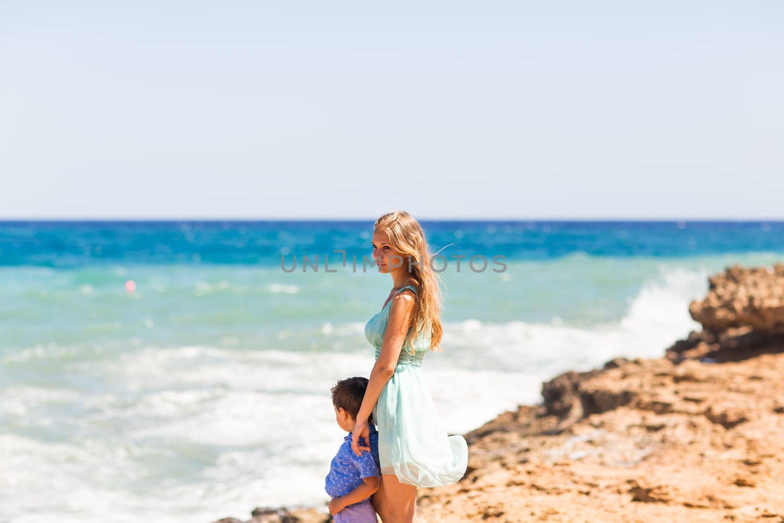 Portrait of happy mother and son at sea, outdoor.