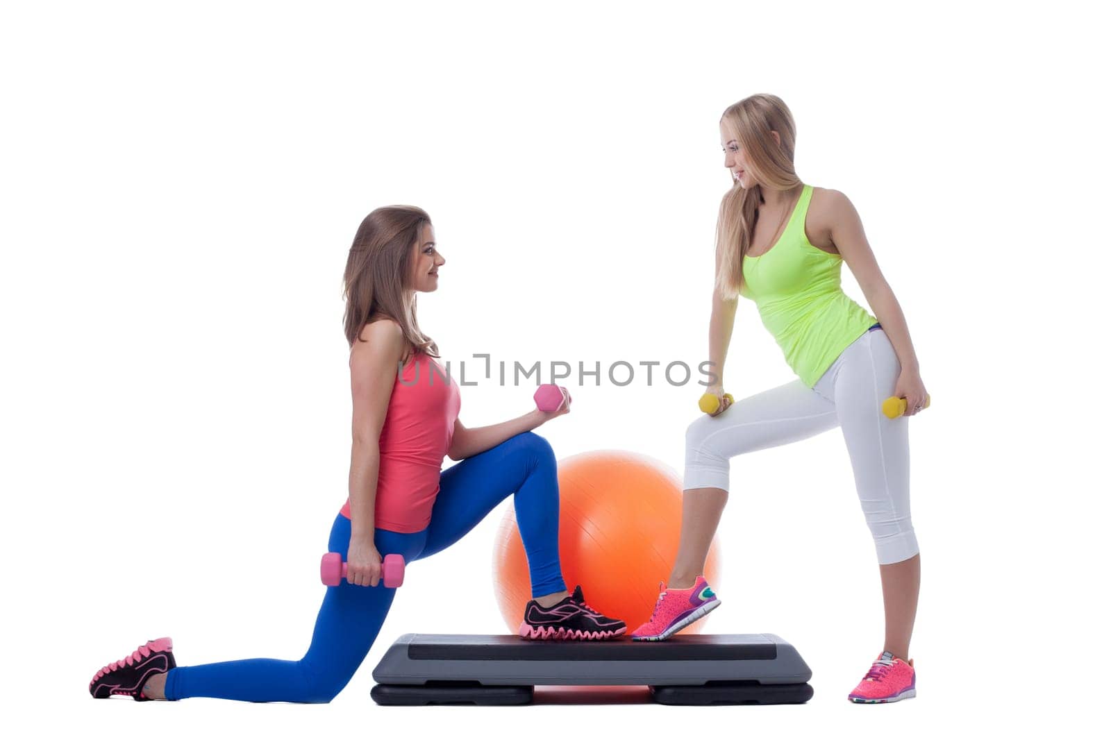 Attractive girlfriends practiced aerobics in studio isolated