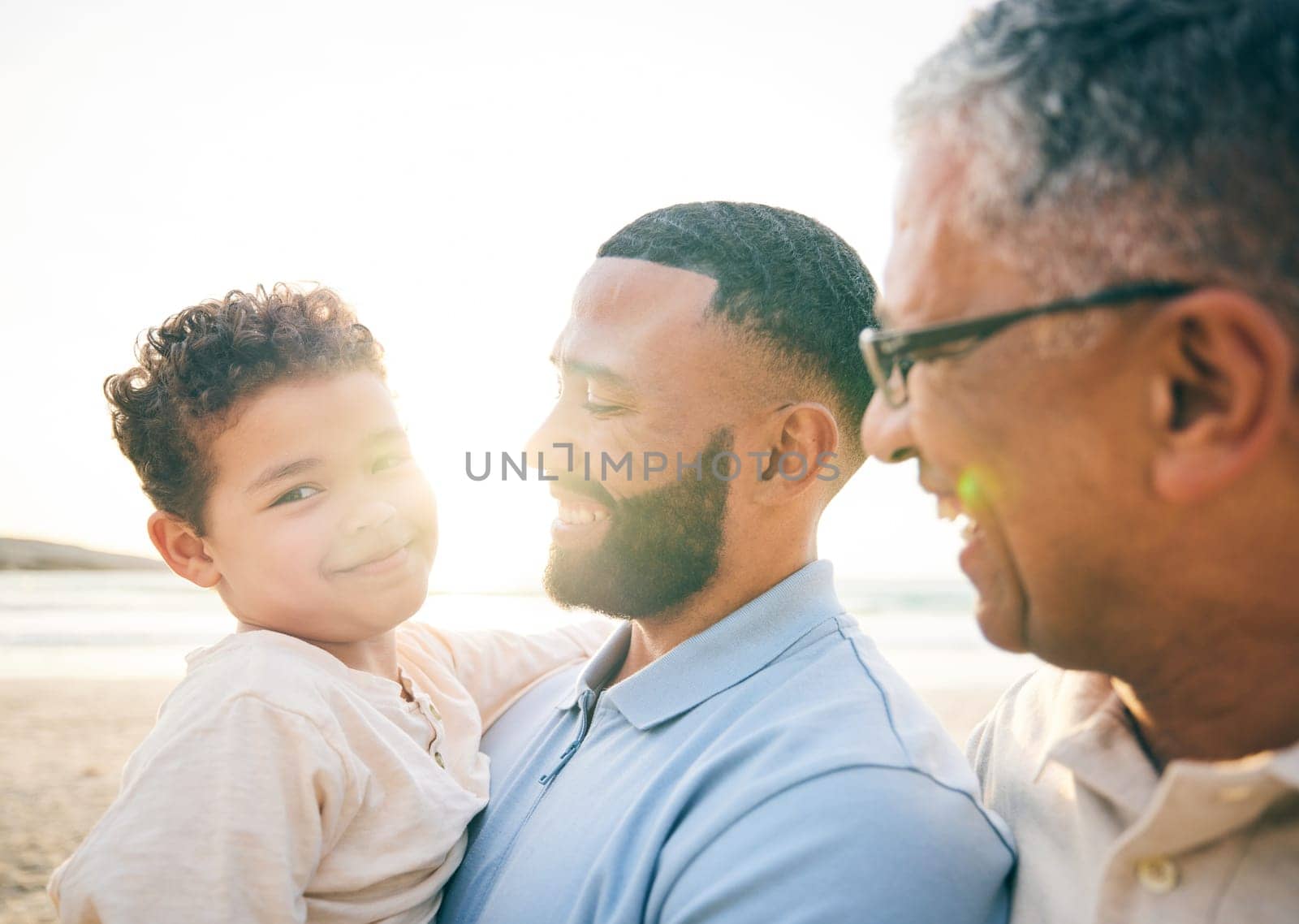 Happy, portrait and family at the beach in the morning for walking, travel or holiday in Spain. Smile, sunshine and father, child and grandfather at the sea for a vacation, care and time at the ocean.