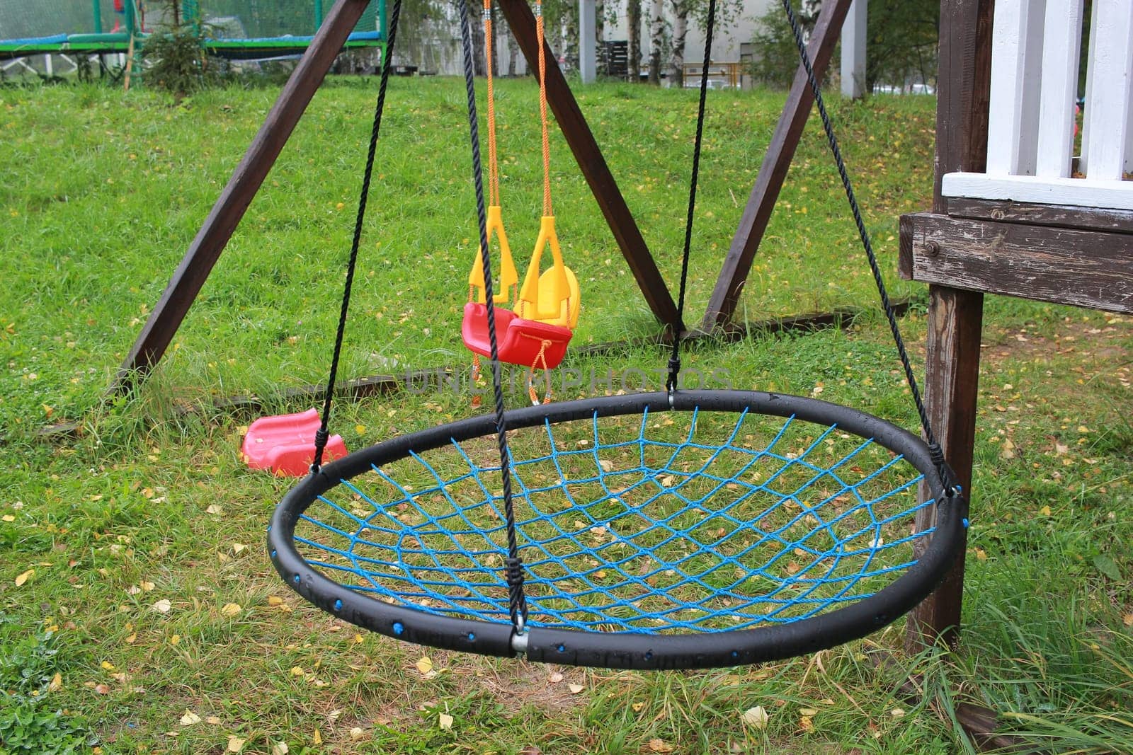 Photo hanging swing for children round. Children's playground. Outdoor games. Entertainment for children.