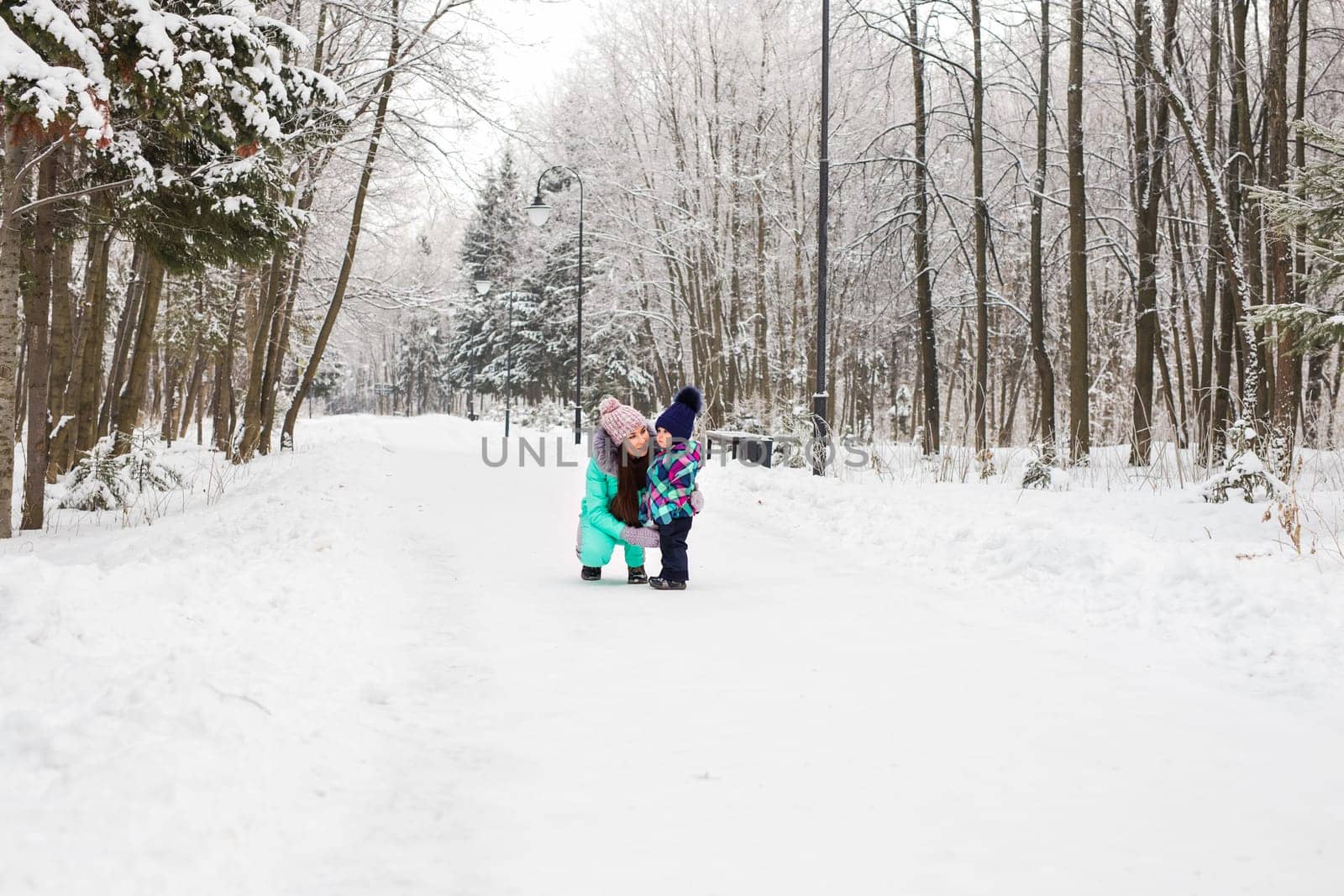 Little girl and her mom having fun on a winter day.