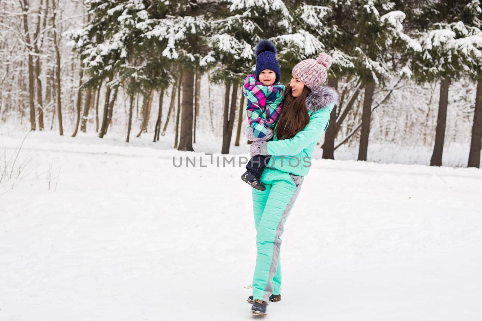 Little girl and her mom having fun on a winter day.