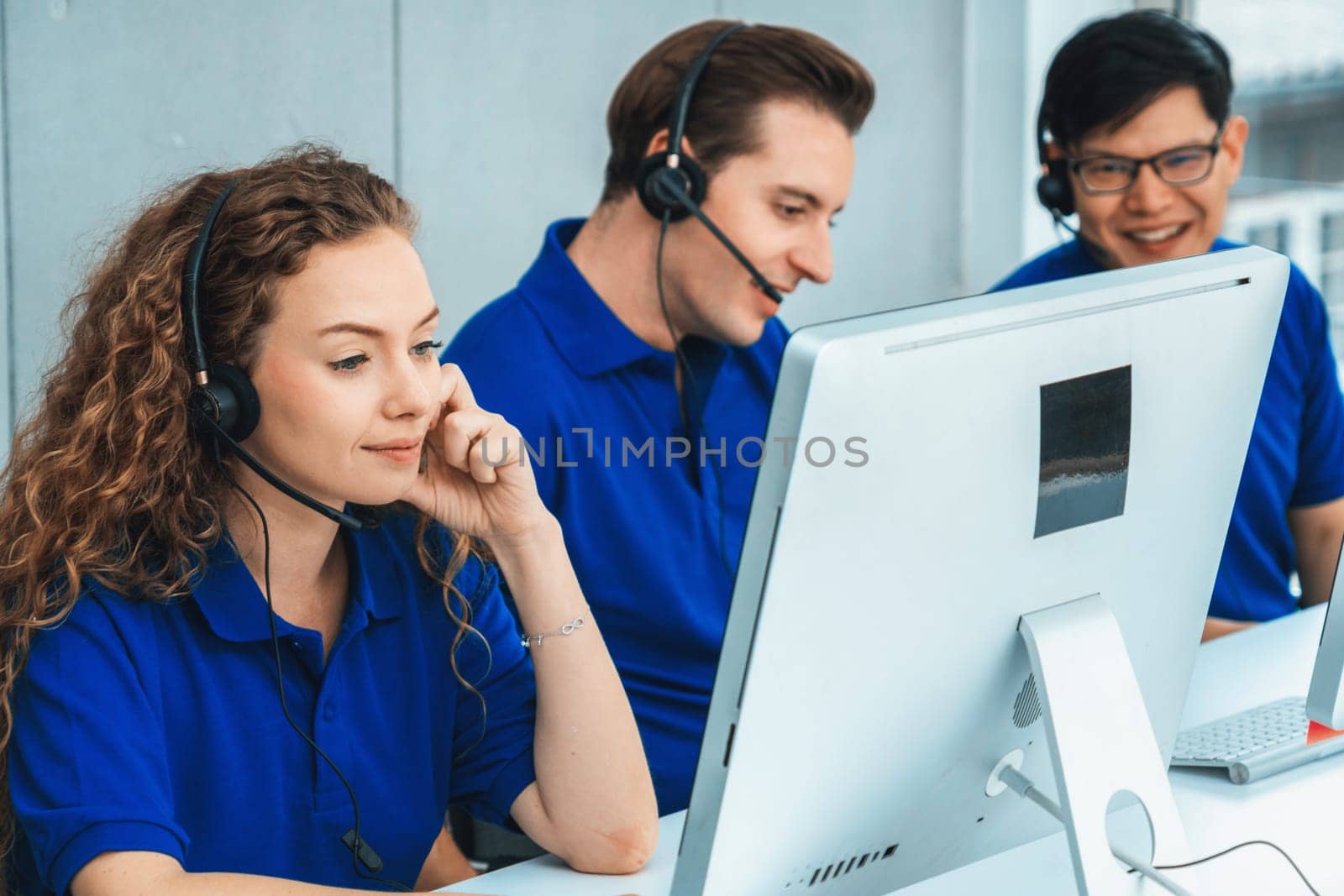 Business people wearing headset working in office to support remote customer or colleague. Call center, telemarketing, customer support agent provide service on telephone video conference call. Jivy