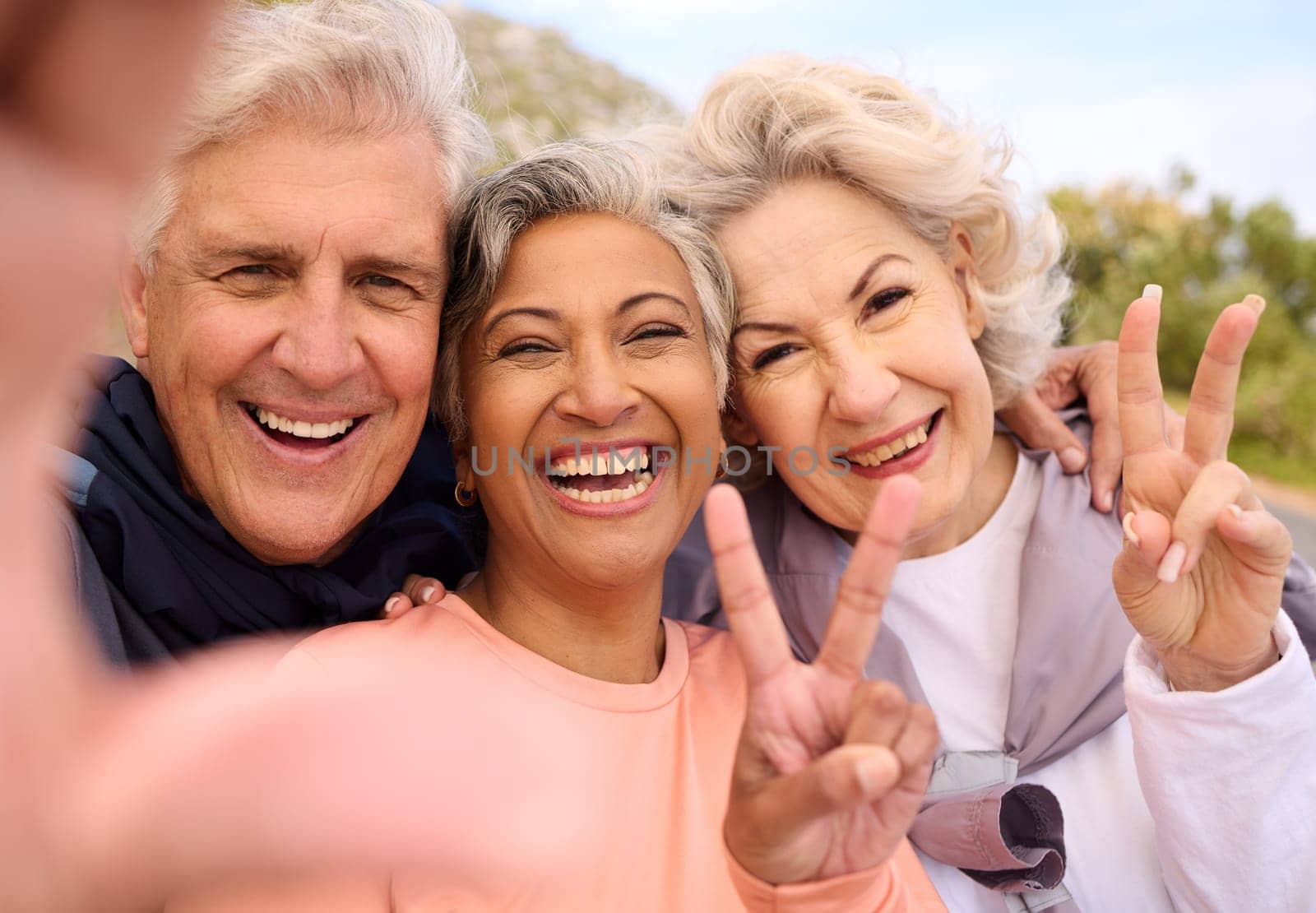 Senior friends, fitness and selfie outdoor with peace sign, portrait and diversity on social media. Happy old man, women and photography for memory, emoji or profile picture for workout in retirement.