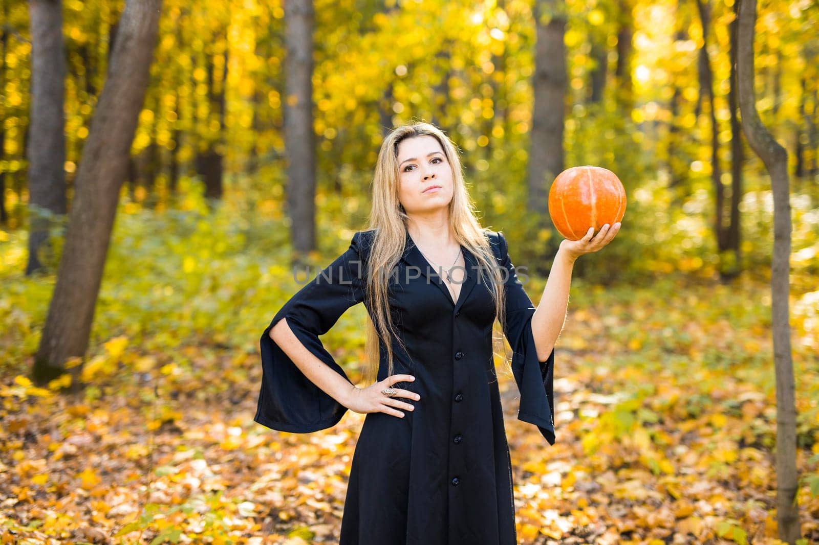 Halloween Witch with Pumpkin in a forest. by Satura86