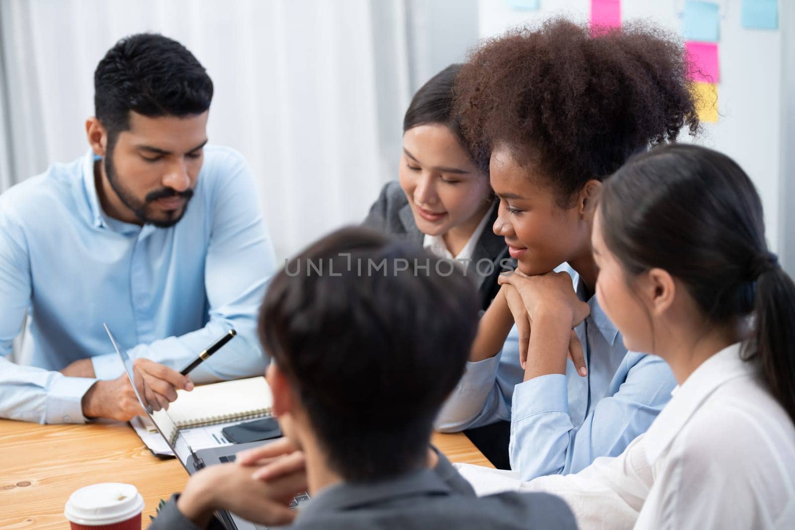 Multiracial analyst team use BI dashboard data to analyze financial report on meeting table. Group of diverse business people utilize data analysis by FIntech for success business marketing. Concord