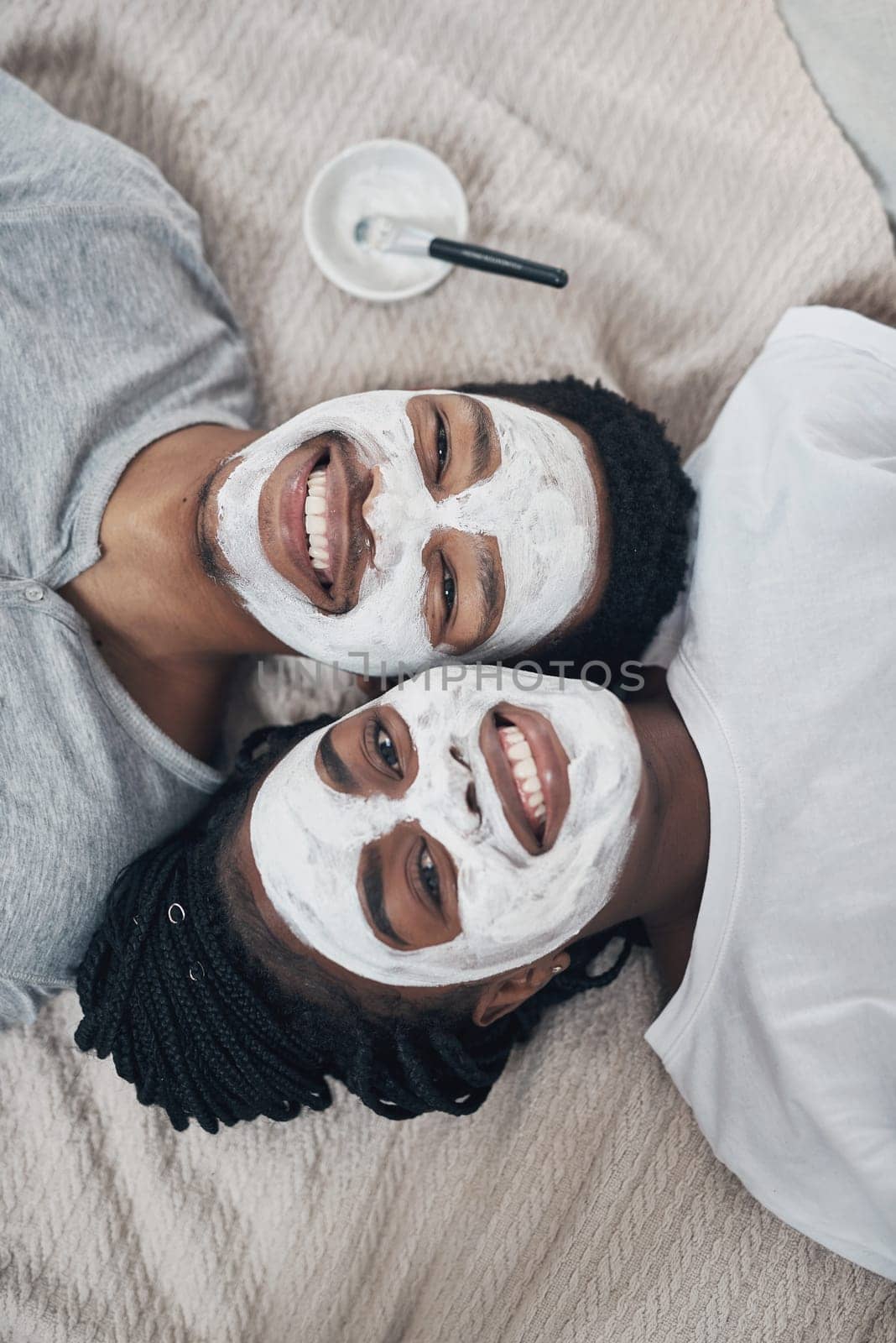 Romance isnt based on gender roles. a young couple getting homemade facials together at home. by YuriArcurs