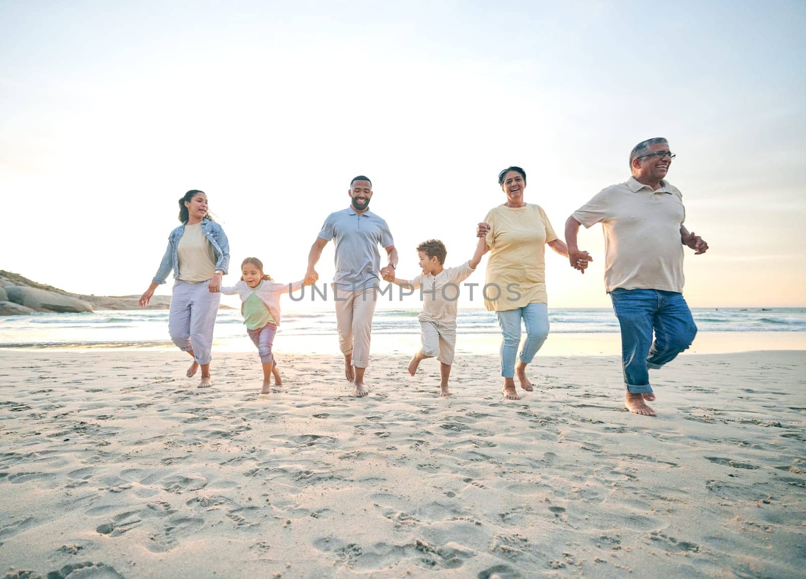 Trust, family and walking with holding hands on beach with freedom with care on vacation with sunshine. Love, children and generations or parents at ocean together for travel with bonding in summer