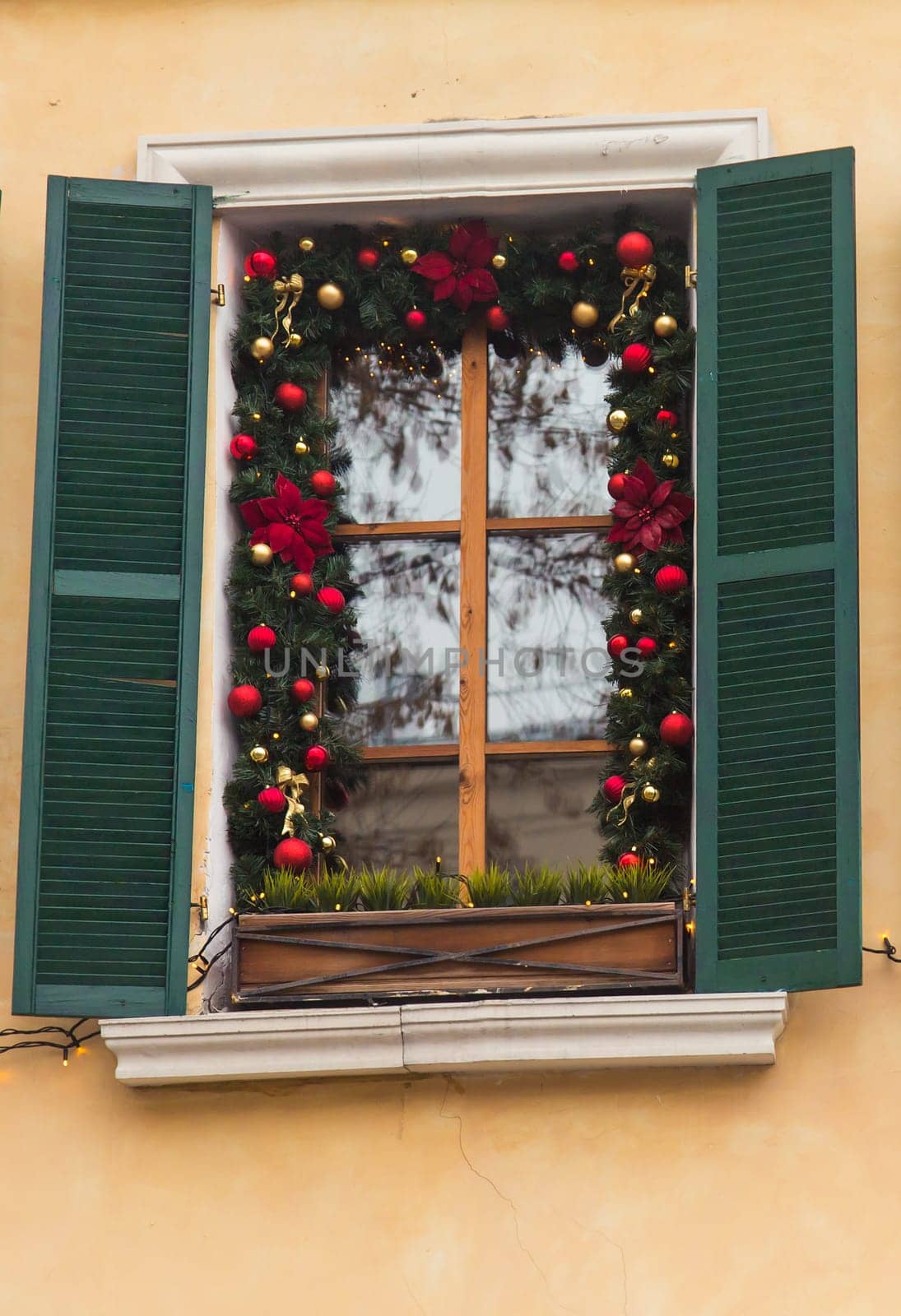 Christmas Red ball decorated windows on vintage house.
