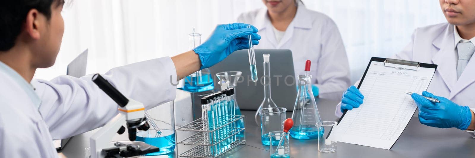 Group of dedicated scientist conduct chemical experiments and research in medical lab as groundbreaking developing for vaccine drug or antibiotic. Pharmaceutical and biochemistry laboratory. Neoteric