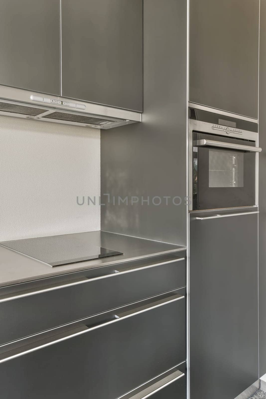 a kitchen with stainless steel appliances and a white counter by casamedia