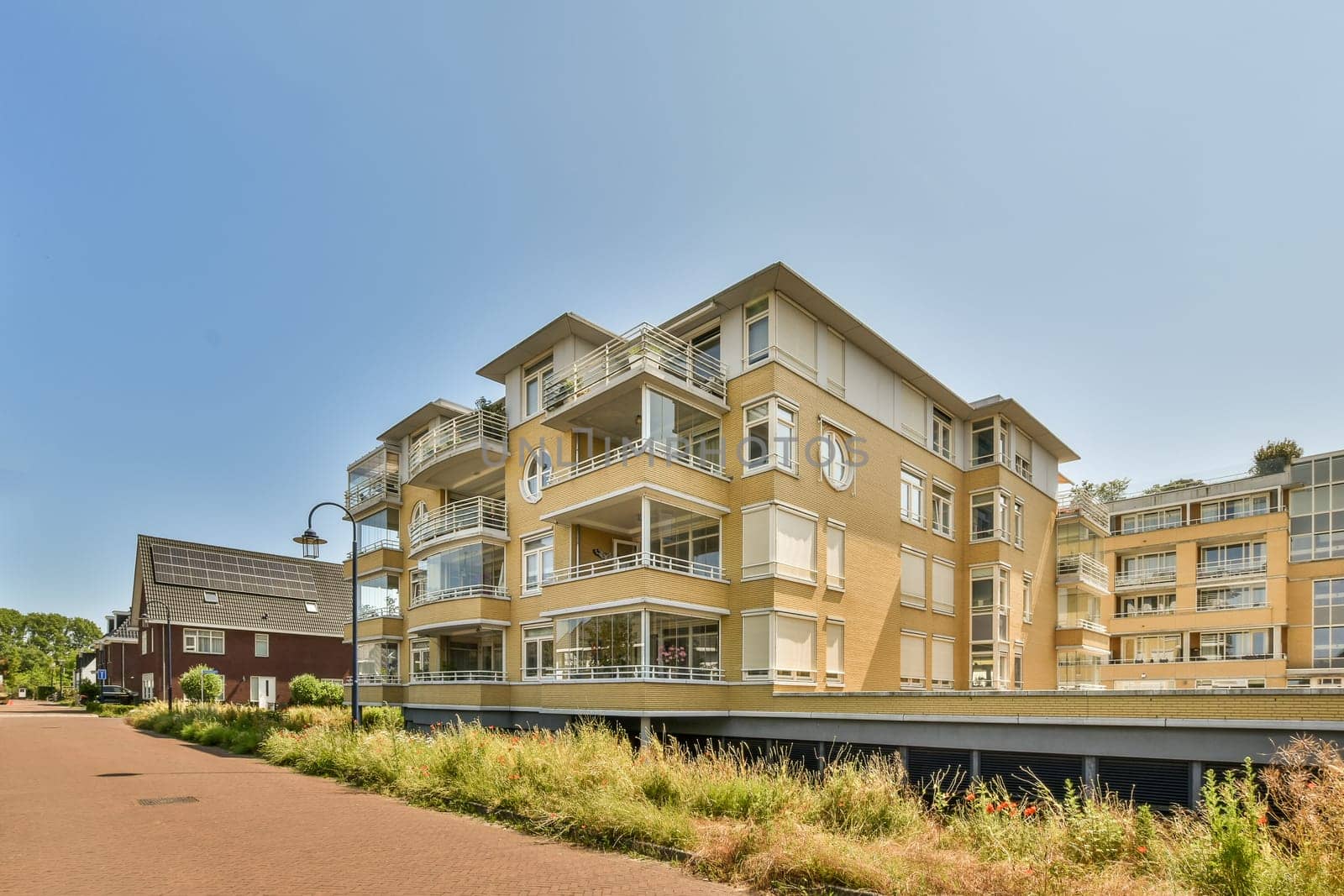 a large apartment building on the side of a road by casamedia