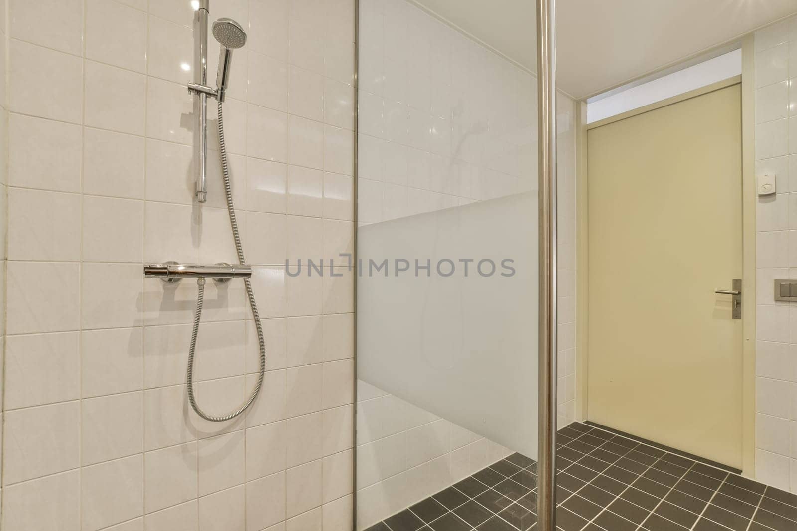 a bathroom with a shower and a sliding glass door by casamedia