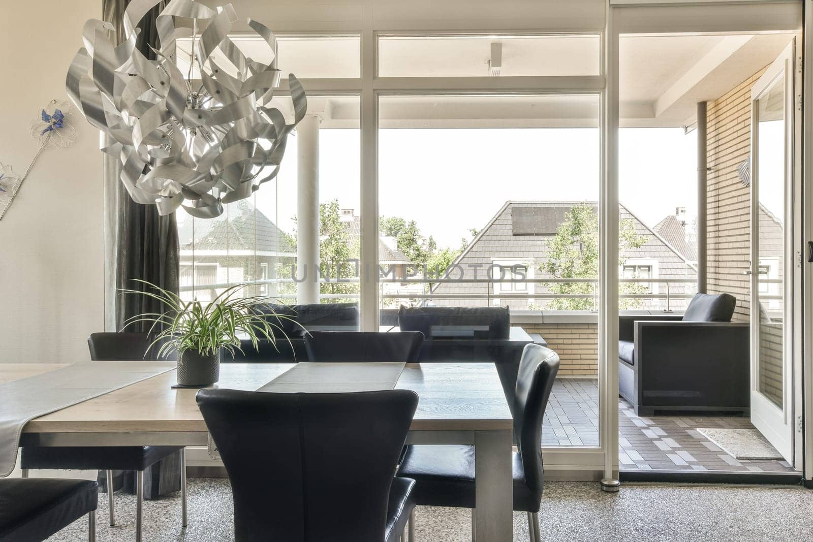 a dining room with a table and chairs and a by casamedia