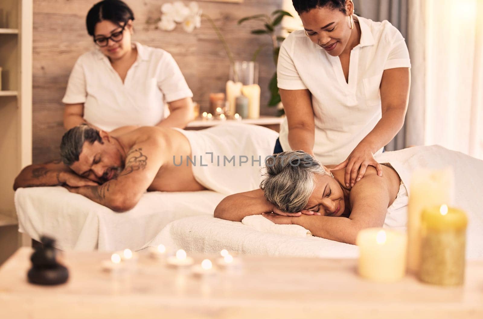 Massage, senior and a couple at the spa to relax on their anniversary together for peace, wellness or bonding. Luxury, beauty or body care with an old woman and man in a salon for physical therapy by YuriArcurs