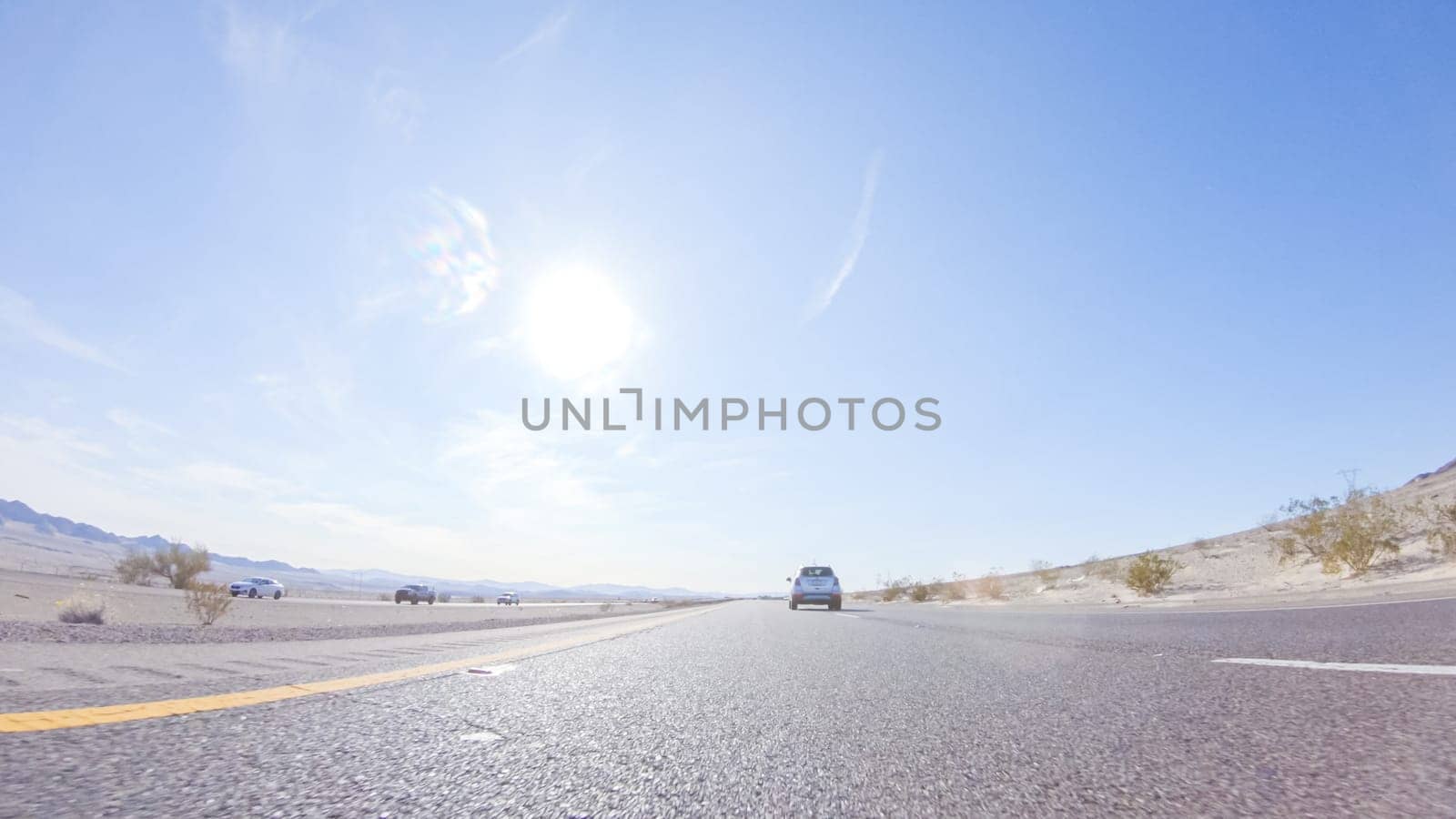 Embarking on a road trip from Nevada to California, driving on Highway 15 during the day offers scenic views and an exciting journey between states.