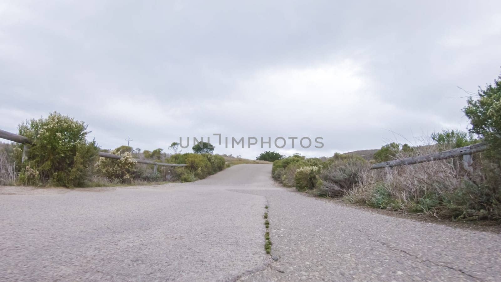 In this serene winter scene, a vehicle carefully makes its way along Los Osos Valley Road and Pecho Valley Road within Montana de Oro State Park.