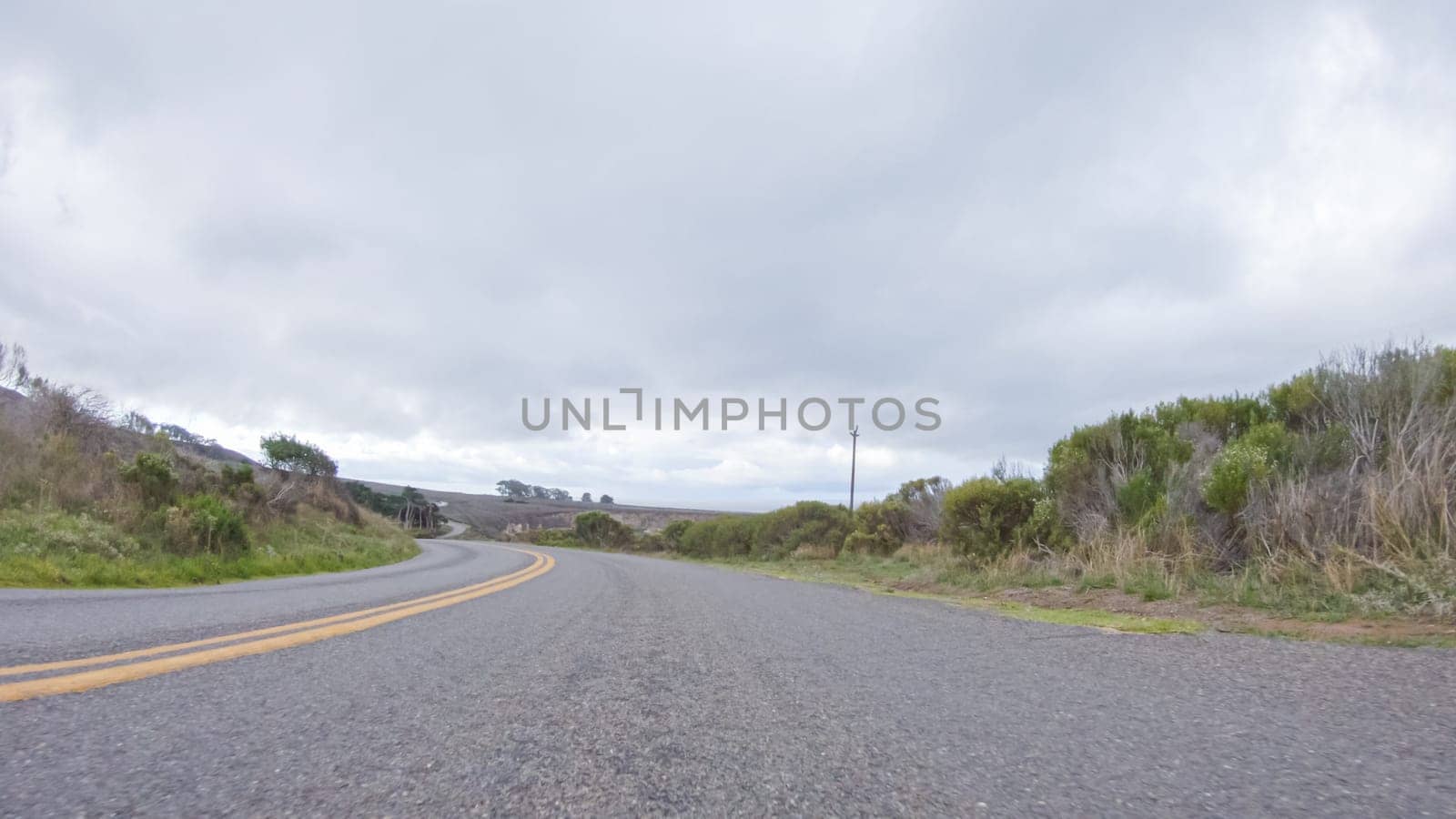 In this serene winter scene, a vehicle carefully makes its way along Los Osos Valley Road and Pecho Valley Road within Montana de Oro State Park.