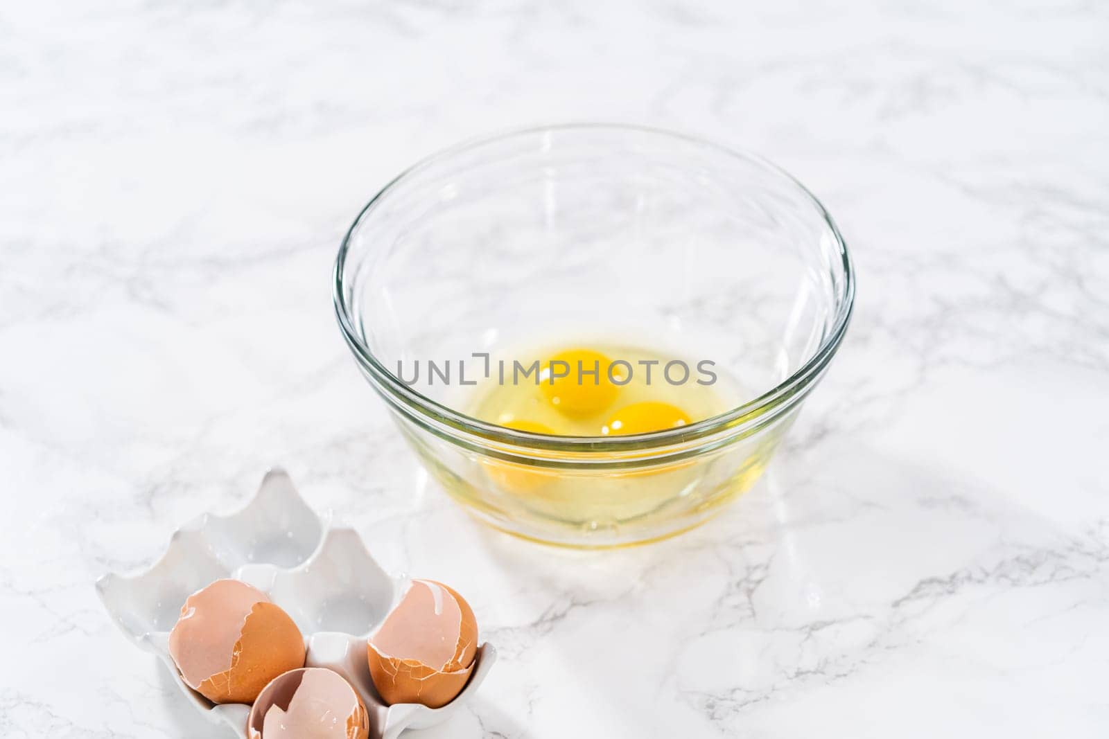 Measured ingredients in glass mixing bowls to bake American flag mini cupcakes.