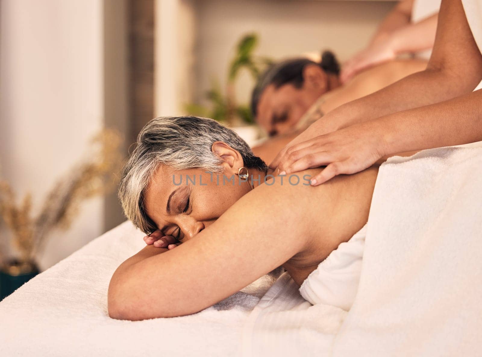 Relax, elderly and a couple at the spa for a massage together for peace, wellness or bonding. Luxury, hospitality or body care with a senior woman and man in a beauty salon for physical therapy by YuriArcurs