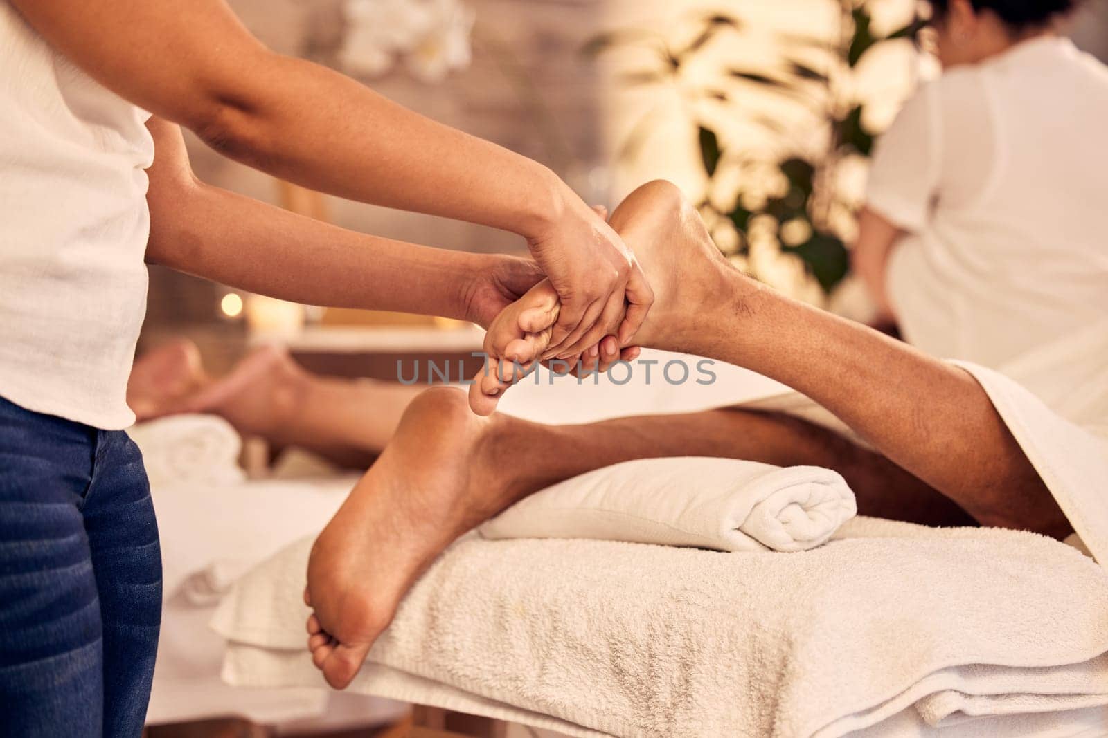 Foot therapist, massage and people at spa for acupressure treatment, holistic therapy or beauty salon. Closeup of feet for skincare, pedicure or muscle reflexology for circulation at wellness service by YuriArcurs