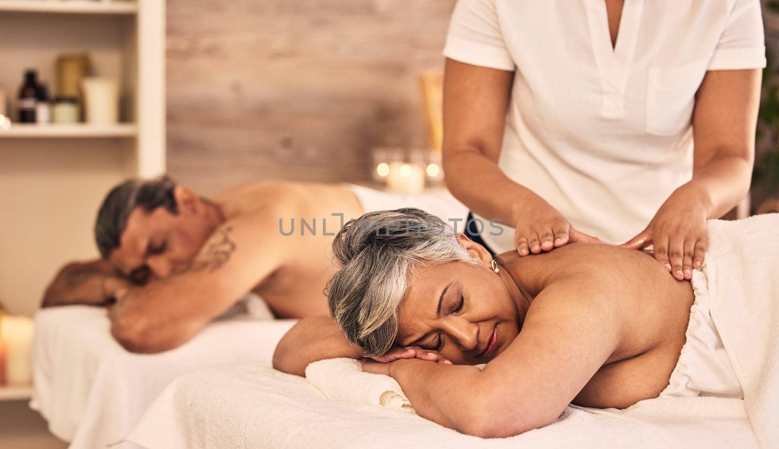 Relax, senior and a couple at the spa for a massage together for peace, wellness or bonding. Luxury, hospitality or body care with an old woman and man in a beauty salon for physical therapy by YuriArcurs