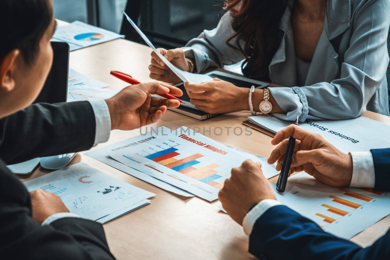 Smart businessman and businesswoman talking discussion in group meeting at office table in a modern office interior. Business collaboration strategic planning and brainstorming of coworkers. Jivy