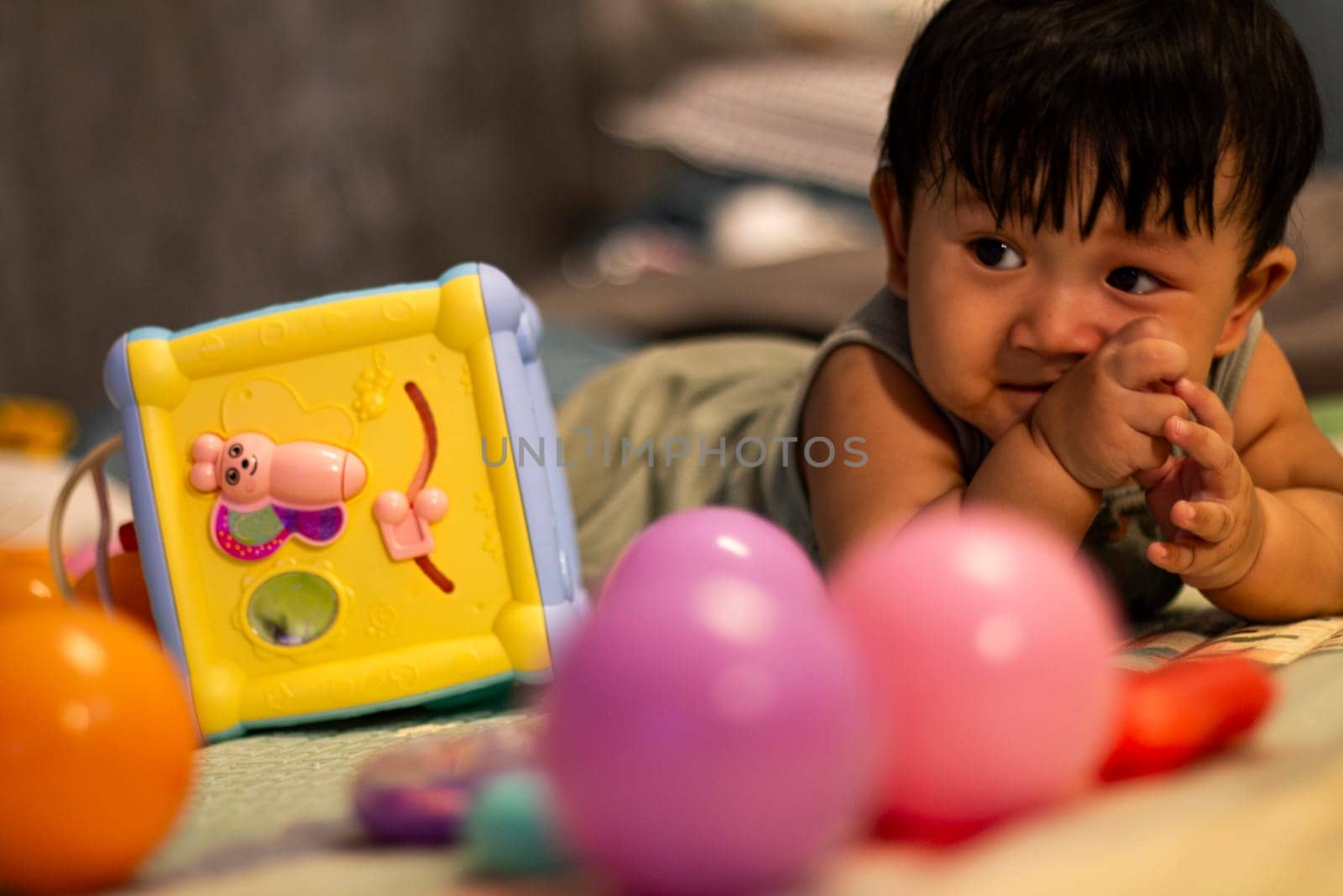 Child playing with colorful toy blocks. Kid playing in the room