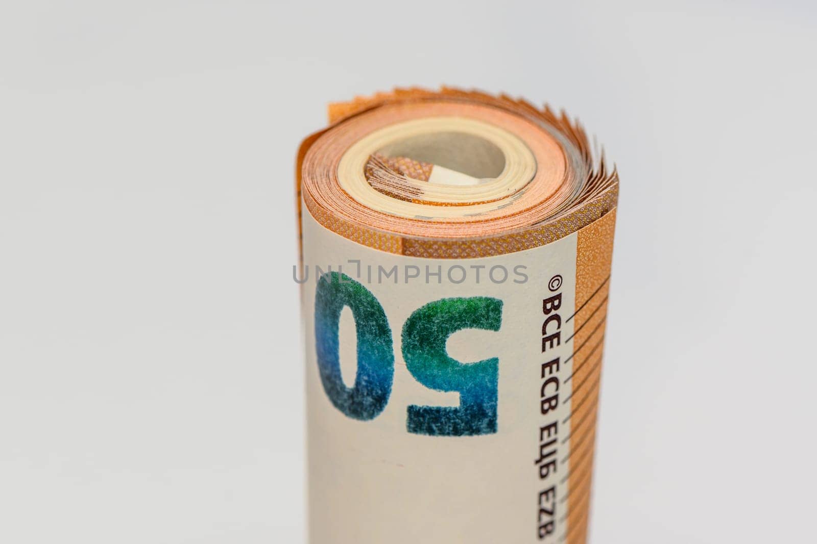 50 euro bills on white background rolled into a tube8 by Mixa74