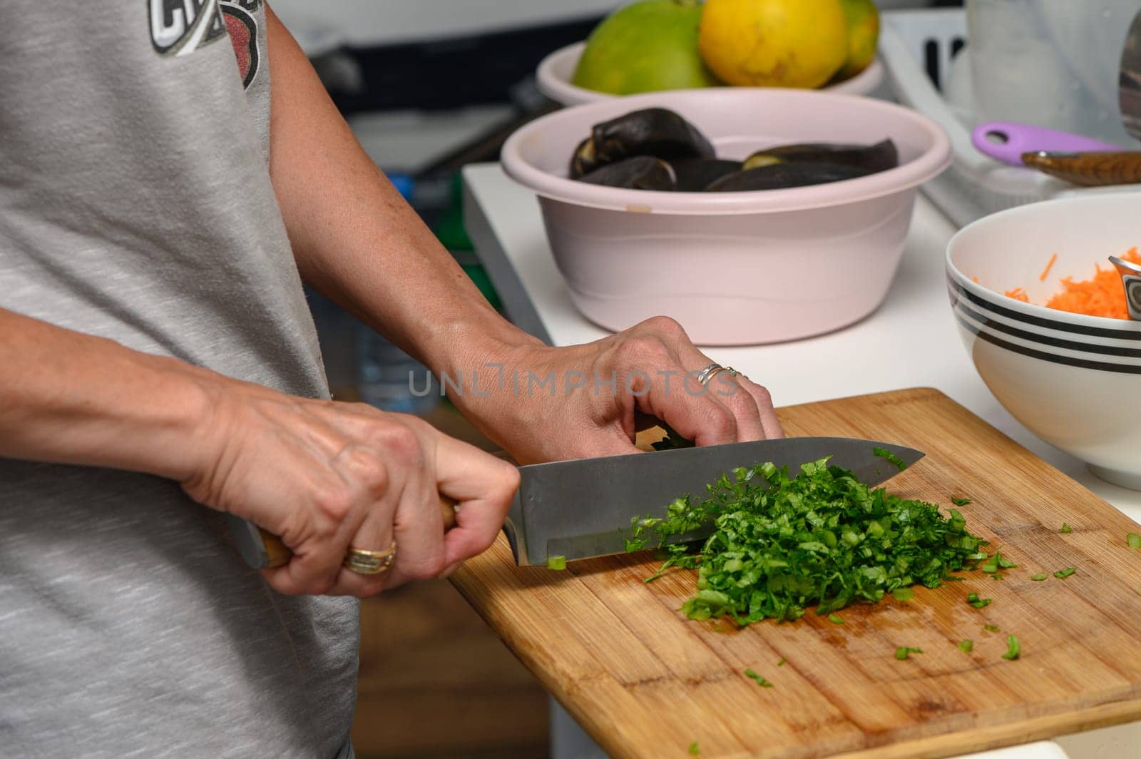 woman cutting parsley on a cutting board in the kitchen 3 by Mixa74