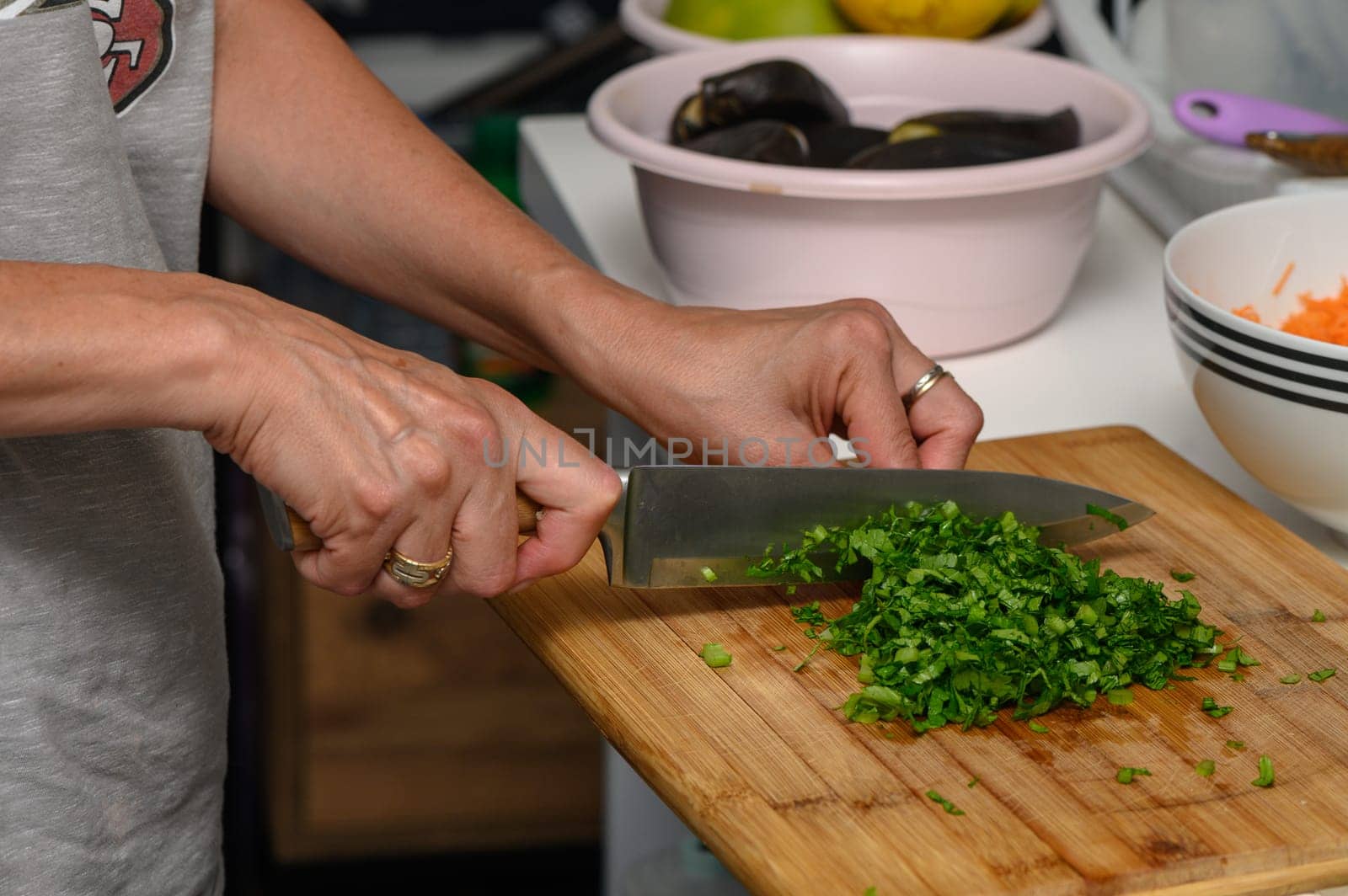 woman cutting parsley on a cutting board in the kitchen 4 by Mixa74