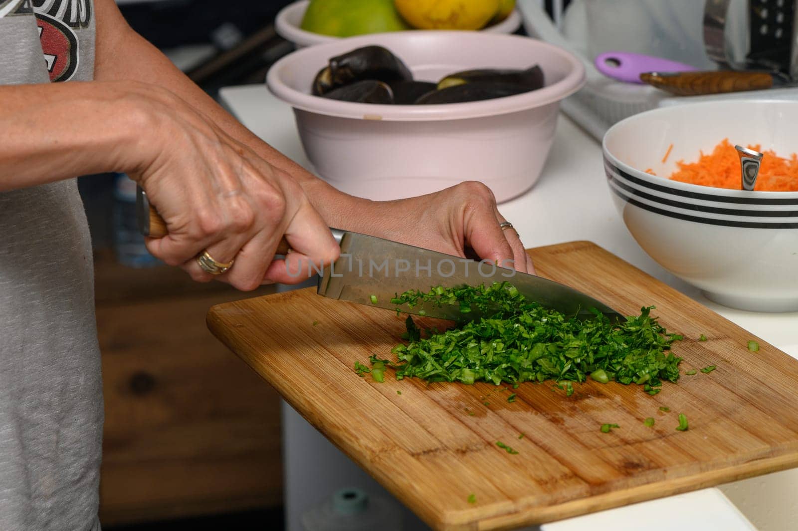 woman cutting parsley on a cutting board in the kitchen 5