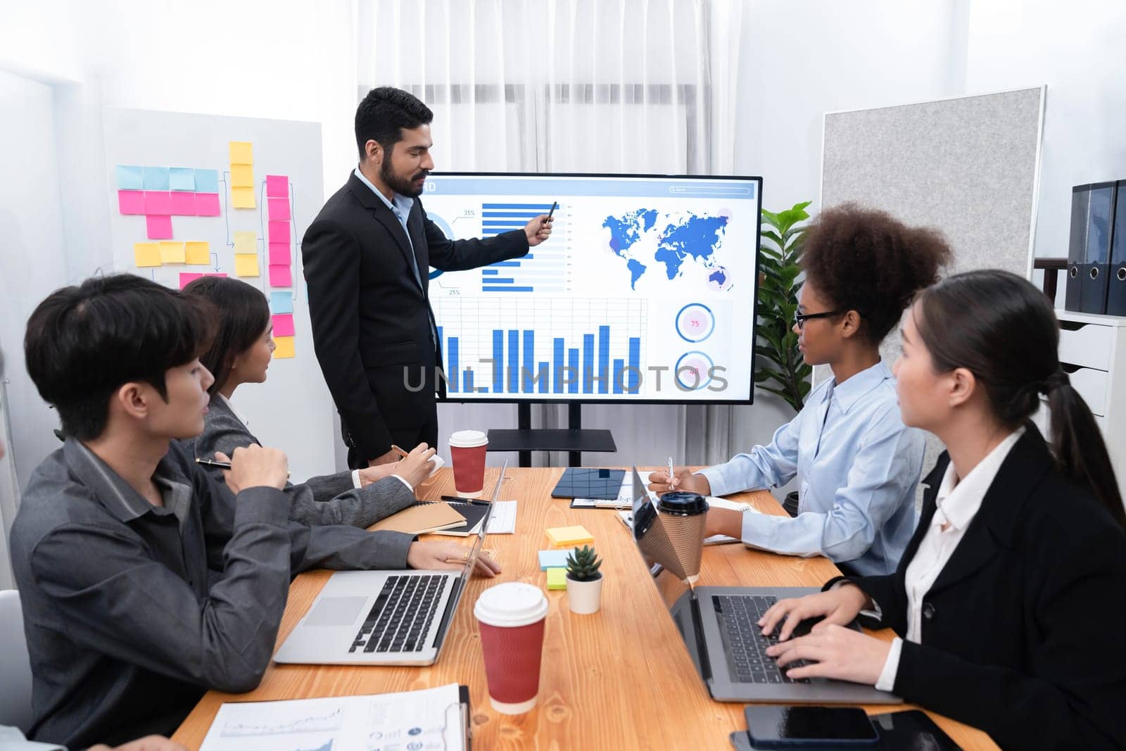 Businessman presenting data analysis dashboard display on TV screen in modern meeting for marketing strategy. Business presentation with group of business people in conference room. Concord