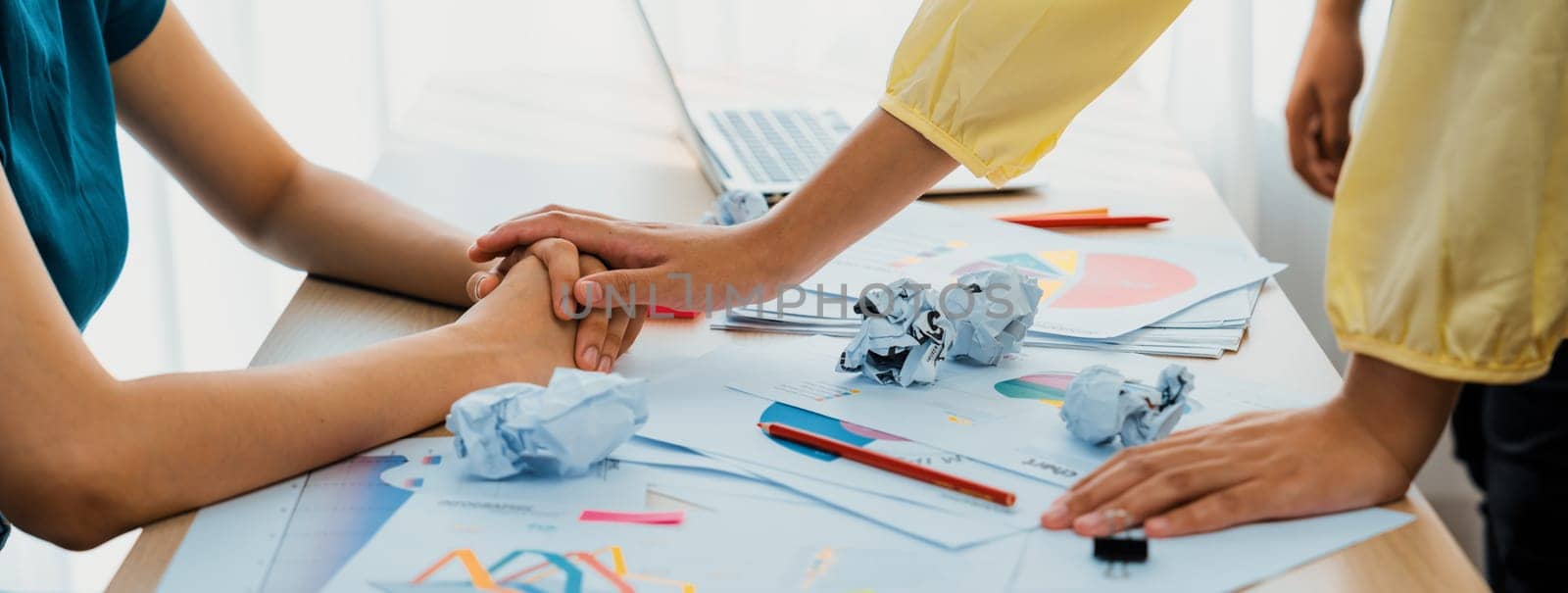 Panorama banner startup employee holding hand to stressful colleague. Synergic by biancoblue