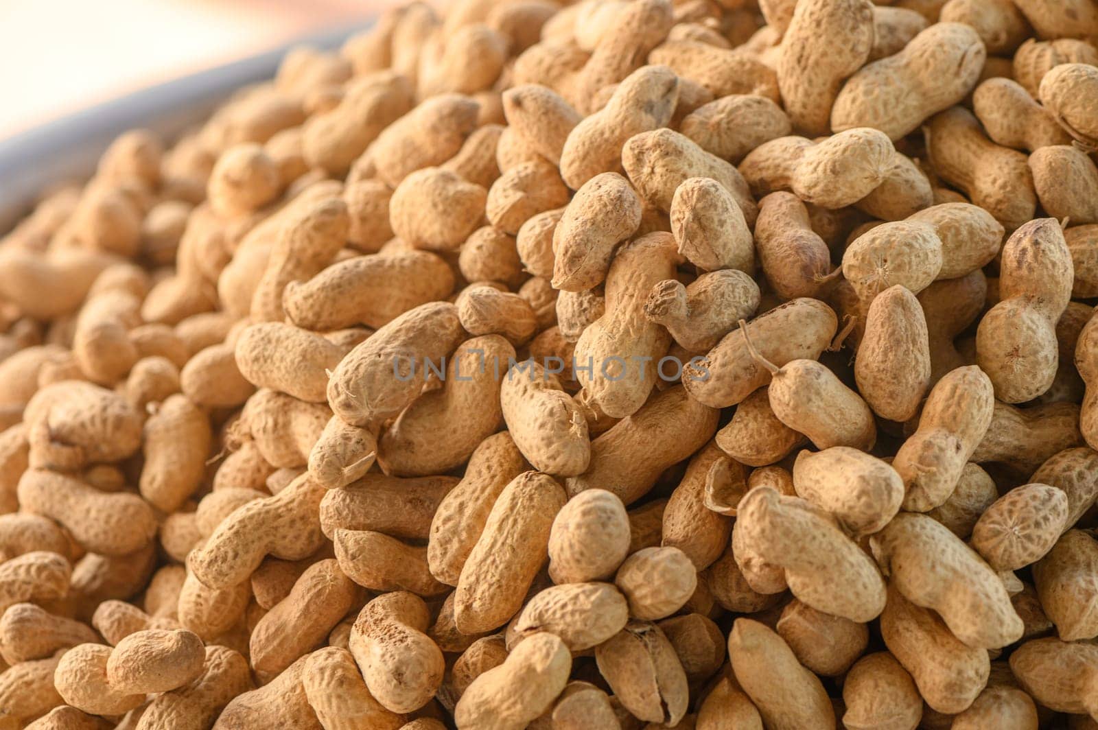 peanuts in pods piled in a pile at the local market
