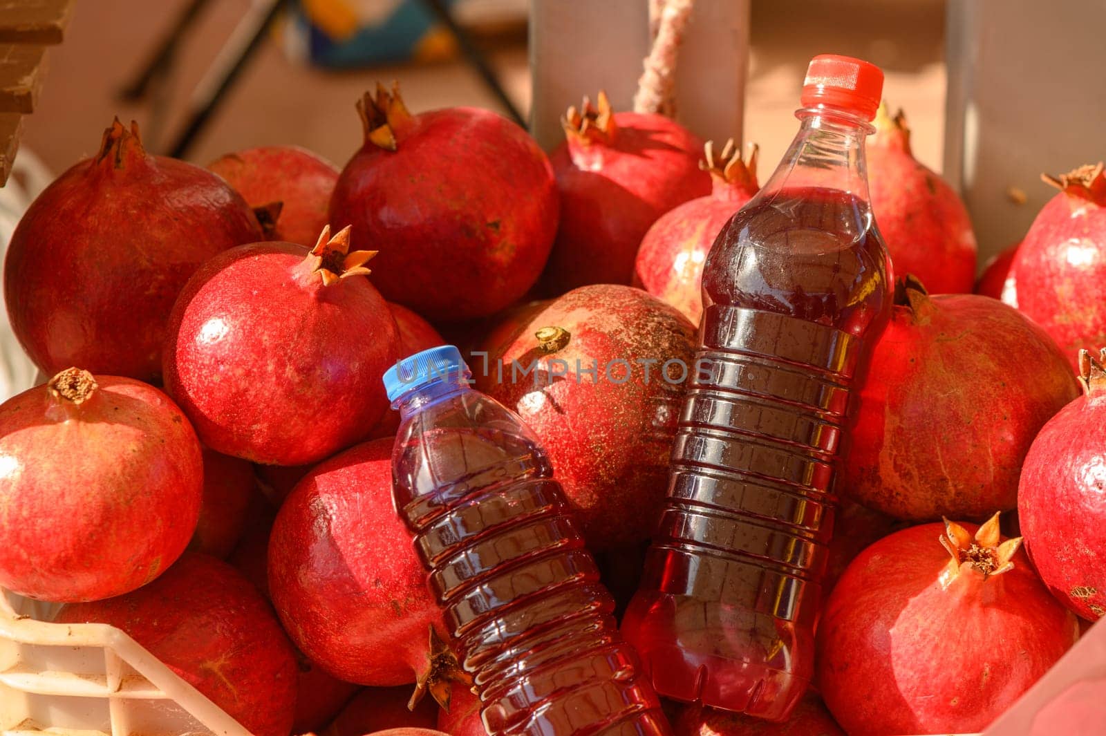 beautiful fresh pomegranates and pomegranate juice in a pile at a local market in the Mediterranean 2