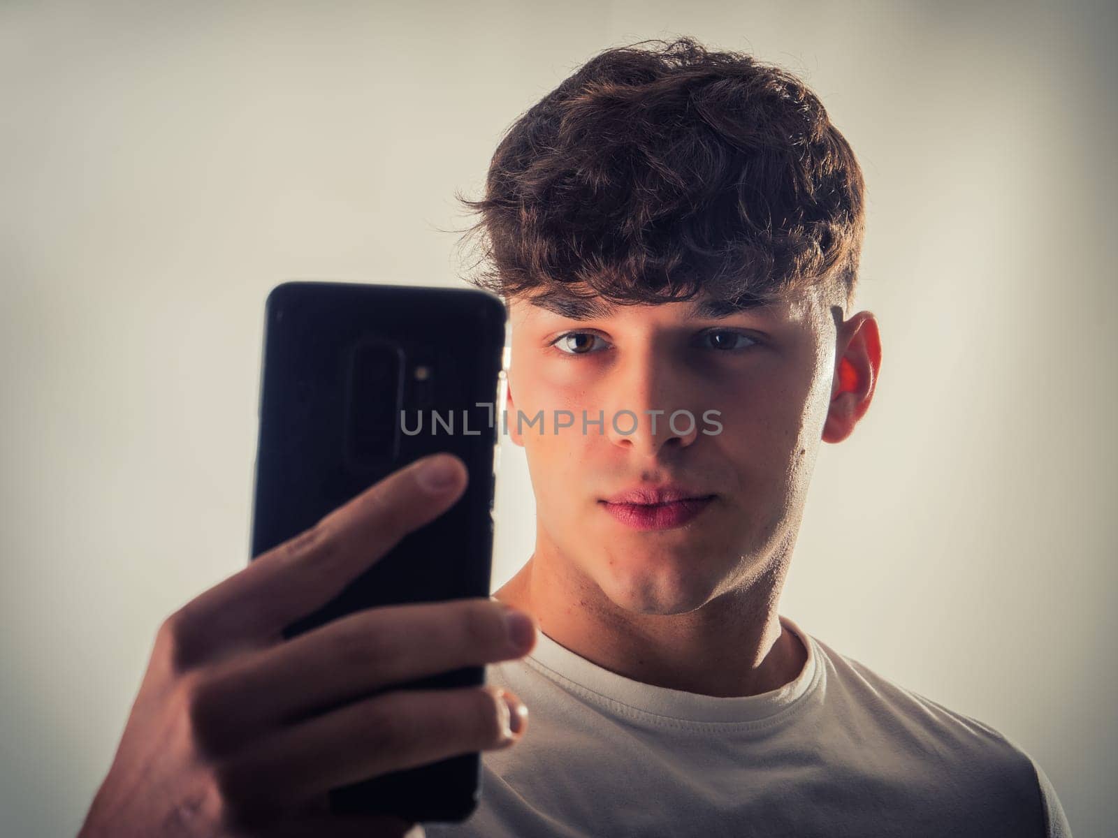 A man taking a picture with his cell phone. Capturing Moments: A Handsome Man's Taking a Photograph with Mobile Phone
