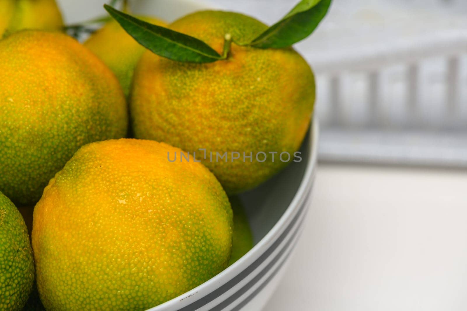 delicious fresh green-orange tangerines in a light plate 3