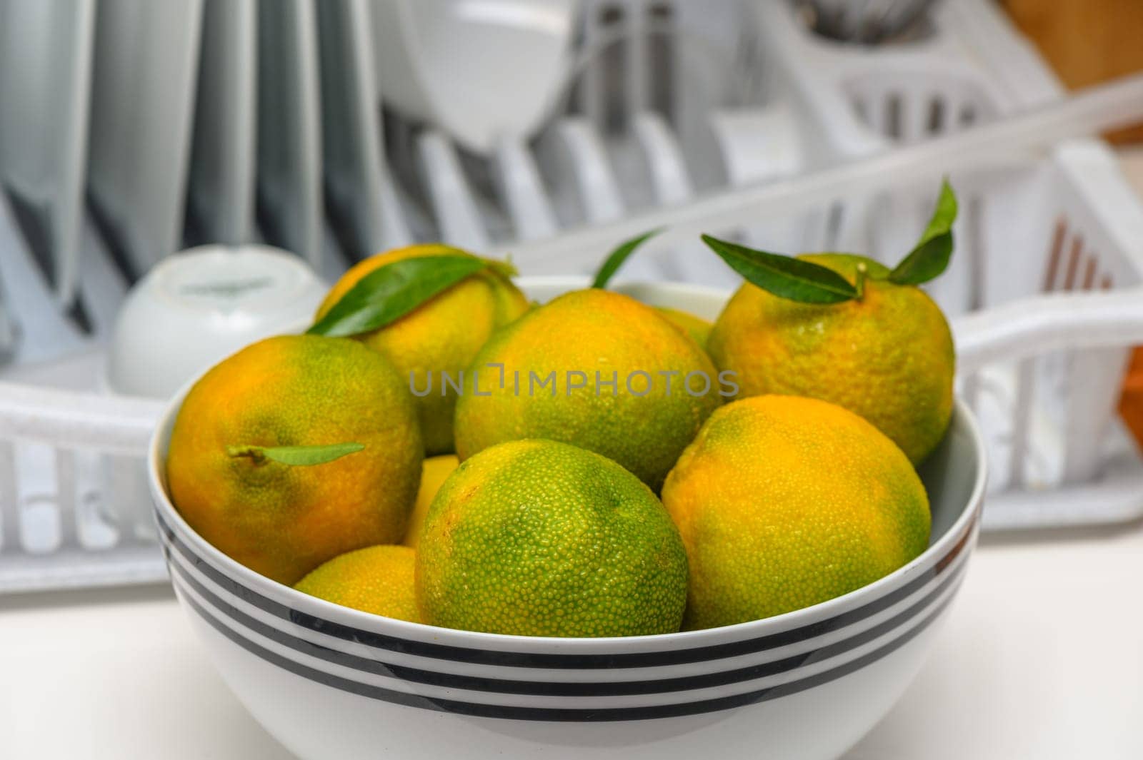 delicious fresh green-orange tangerines in a light plate 2