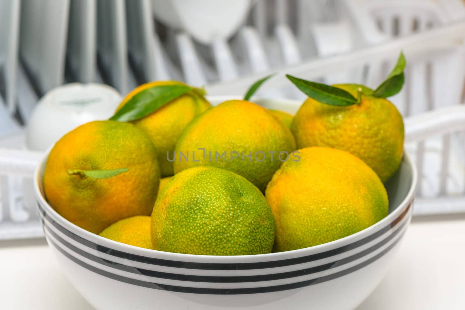 delicious fresh green-orange tangerines in a light plate 2 by Mixa74