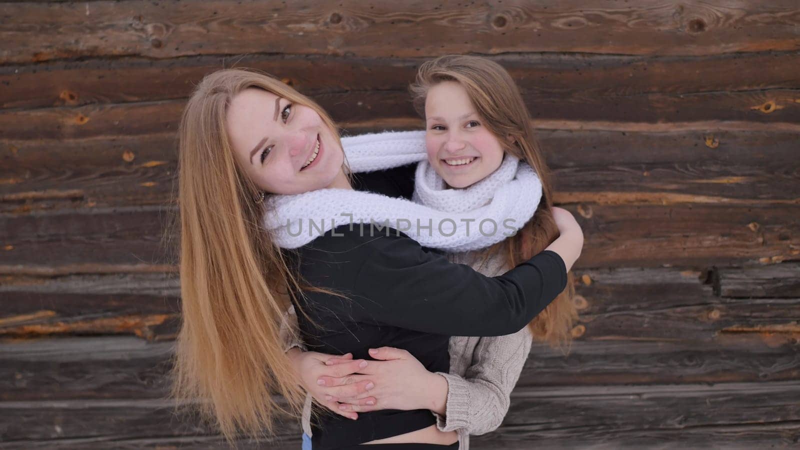Young friends posing in the village in winter