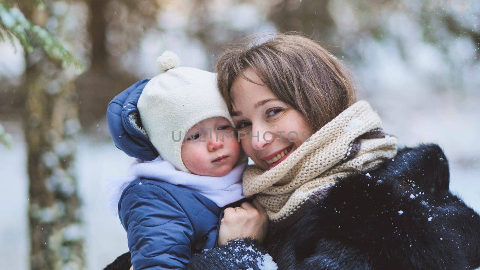 A baby and his mother in the winter woods