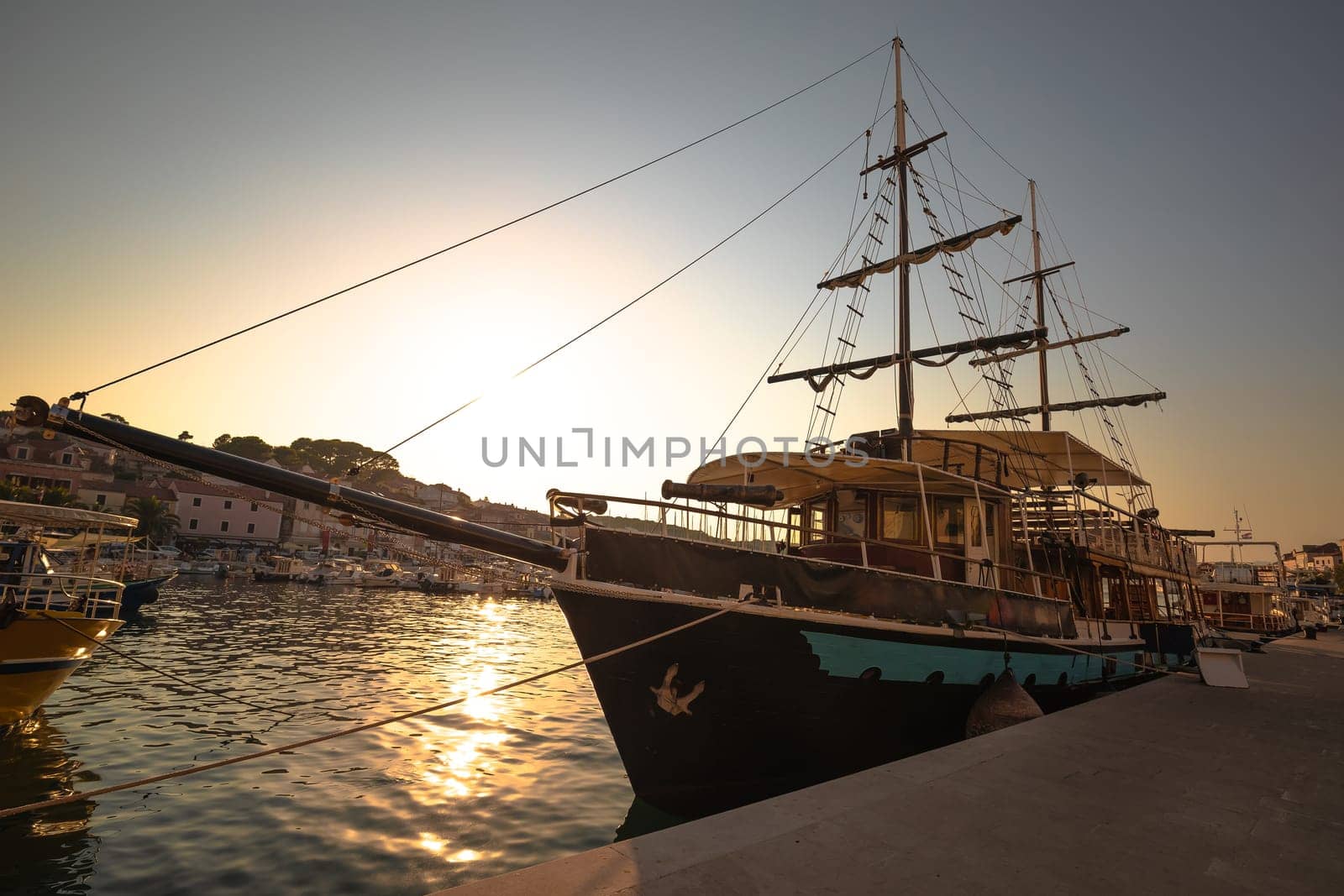 Mali Losinj harbor historic wooden sailboat sunset view, Island of Losinj, archipelago of Croatia