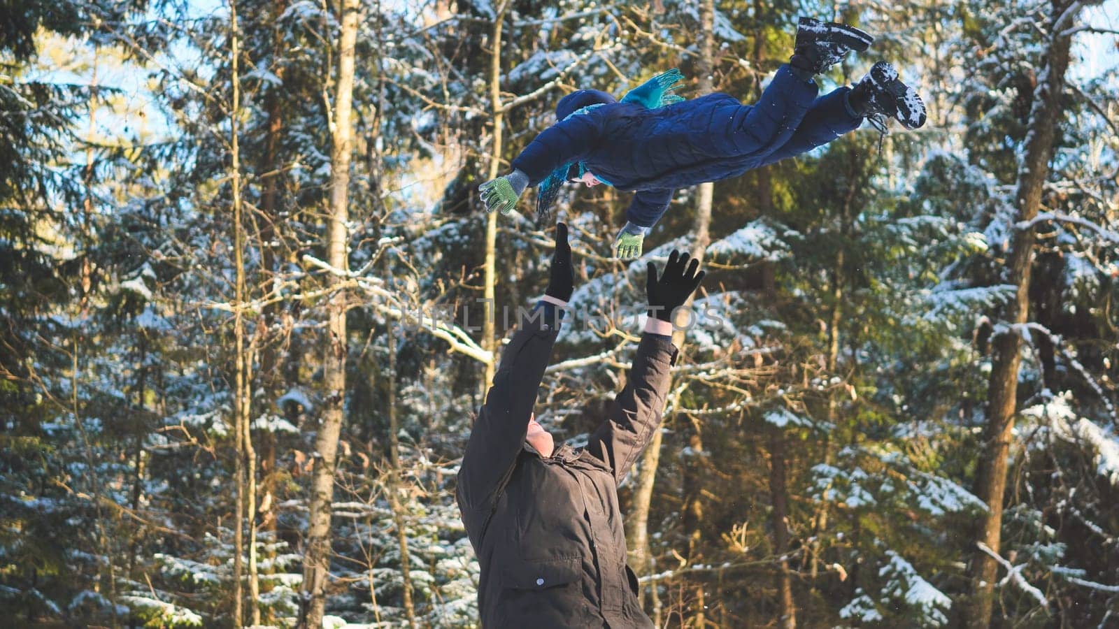 A happy father drops his son off in the winter in the woods. by DovidPro